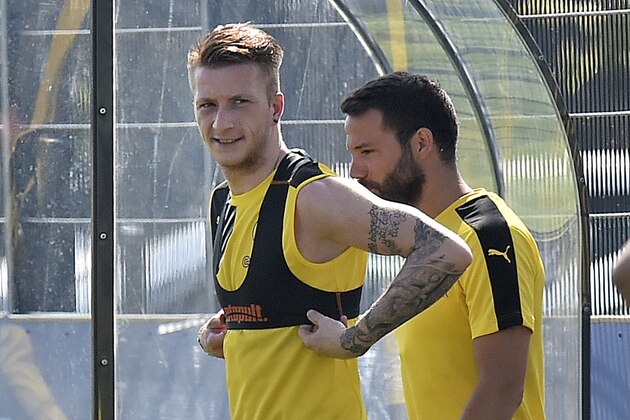 Dortmund's Marco Reus, left, arrives with new player Gonzalo Castro during the first open training session for the new season in Dortmund, Germany, Tuesday, June 30, 2015. The new Bundesliga season starts August 14. (AP Photo/Martin Meissner)