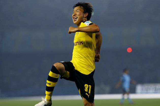 Dortmund's Mitsuru Maruoka  celebrates his goal against Kawasaki Frontale during their test soccer match in Kawasaki, south of Tokyo, Tuesday, July 7, 2015.(AP Photo/Shuji Kajiyama)