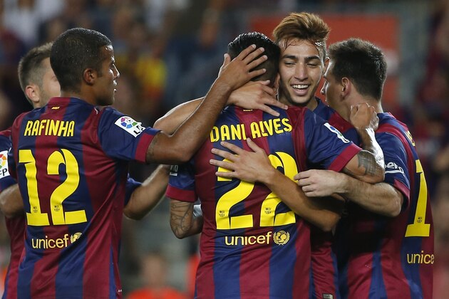 Barcelona's Munir, right, celebrate with teammates scoring his side's fourth goal during the Joan Gamper trophy friendly soccer match between Barcelona and Leon at the Camp Nou stadium in Barcelona, Spain, Monday, Aug. 18, 2014. (AP Photo/Emilio Morenatti)