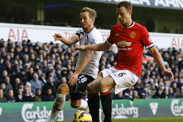 Tottenham's Harry Kane, left, vies for the ball with Manchester United's Jonny Evans during the English Premier League soccer match between Tottenham Hotspur and Manchester United at White Hart Lane Stadium in London, Sunday, Dec. 28, 2014. (AP Photo/Kirsty Wigglesworth)