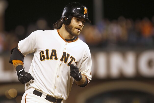 San Francisco Giants' Brandon Crawford rounds the bases after hitting a solo home run against San Diego Padres during the fourth nning of a baseball game in San Francisco, Thursday, Sept. 25, 2014. (AP Photo/Tony Avelar)