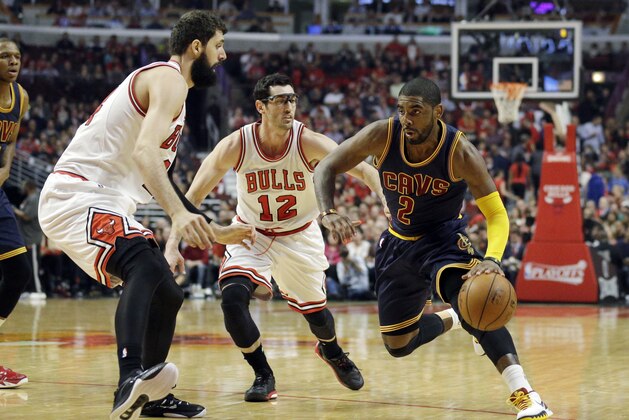 Cleveland Cavaliers guard Kyrie Irving (2) drives on Chicago Bulls guard Kirk Hinrich (12) and Nikola Mirotic (44) during the first half of Game 6 in a second-round NBA basketball playoff series in Chicago on Thursday, May 14, 2015. (AP Photo/Nam Y. Huh)