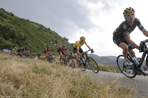 Britain's Geraint Thomas, right, Britain's Chris Froome, wearing the overall leader's yellow jersey, and Tejay van Garderen of the U.S., in fourth position, speed downhill during the twelfth stage of the Tour de France cycling race over 195 kilometers (121.2 miles) with start in Lannemezan and finish in Plateau de Beille, France, Thursday, July 16, 2015. (AP Photo/Laurent Cipriani)