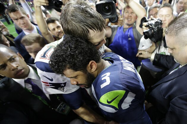 New England Patriots quarterback Tom Brady (12) hugs Seattle Seahawks quarterback Russell Wilson (3) after the NFL Super Bowl XLIX football game Sunday, Feb. 1, 2015, in Glendale, Ariz.  The Patriots won 28-24. (AP Photo/David J. Phillip)