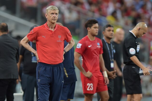 Arsenal's manager Arsene Wenger looks on as his team plays the Singapore selection in a soccer match for the Barclays Asia Trophy in Singapore, Wednesday, July 15, 2015.(AP Photo/Joseph Nair)