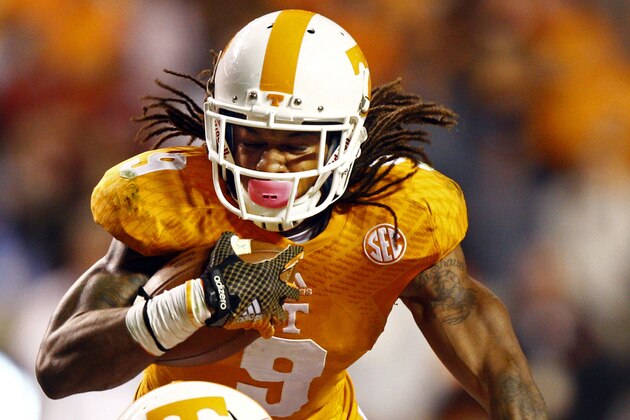 Tennessee wide receiver Von Pearson (9) runs for yardage as he is hit by Alabama defensive back Nick Perry (27) in the third quarter of an NCAA college football game Saturday, Oct. 25, 2014, in Knoxville, Tenn. (AP Photo/Wade Payne)