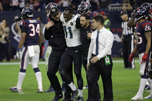 Jacksonville Jaguars wide receiver Marqise Lee (11) is helped off the field after an injury during the second half of an NFL football game against the Houston Texans Sunday, Dec. 28, 2014, in Houston. (AP Photo/David J. Phillip)