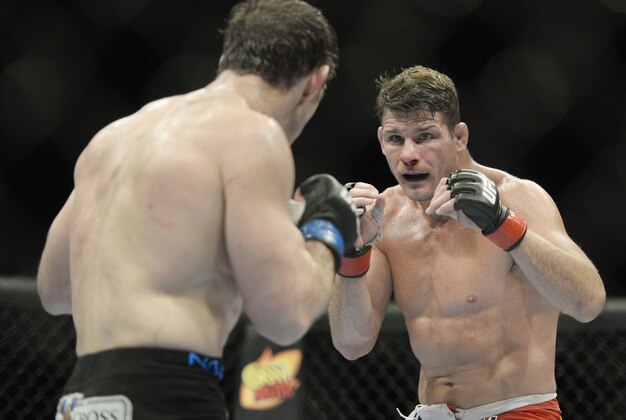 Apr 16, 2014; Quebec City, Quebec, Canada; Michael Bisping (red gloves) fights against Tim Kennedy (blue gloves) during their middleweight bout at Colisee Pepsi. Mandatory Credit: Eric Bolte-USA TODAY Sports