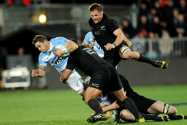 Argentina’s Facundo Isa tackled by New Zealand’s Keven Mealamu with Richie McCaw, right, during their rugby test match in Christchurch, New Zealand, Friday, July 17, 2015. (AP Photo/SNPA, Ross Setford)  **NEW ZEALAND OUT**