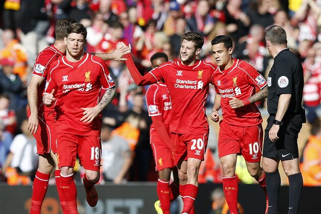 Liverpool's Adam Lallana, centre, celebrates after scoring the opening goal during the English Premier League soccer match between Liverpool and Crystal Palace at Anfield Stadium, Liverpool, England, Saturday, May 16, 2015. (AP Photo/Jon Super)