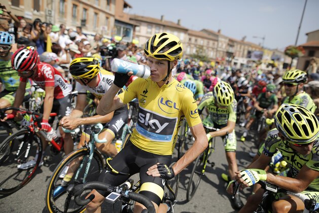 Britain's Chris Froome, wearing the overall leader's yellow jersey, drinks as he waits for the start of the thirteenth stage of the Tour de France cycling race over 198.5 kilometers (123.3 miles) with start in Muret and finish in Rodez, France, Friday, July 17, 2015. (AP Photo/Laurent Cipriani)