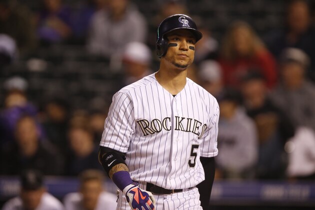 Colorado Rockies right fielder Carlos Gonzalez (5) looks on against the Los Angeles Angels in the fourth inning of an inter league baseball game Wednesday, July 8, 2015, in Denver. The Angels won 3-2. (AP Photo/David Zalubowski)