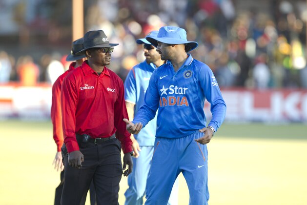 Indian bowler Harbhajan Singh, right, talks to the umpire after the match on the second day of the One Day International  cricket match against Zimbabwe in  Harare, Zimbabwe, Sunday, July,12, 2015.   (AP Photo/Tsvangirayi Mukwazhi)