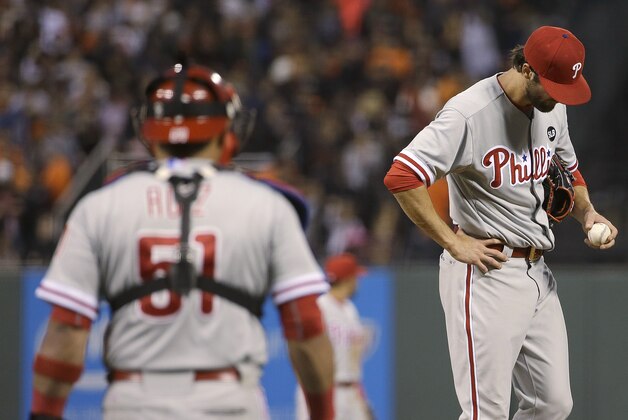 Philadelphia Phillies pitcher Cole Hamels, right, stands on the mound as catcher Carlos Ruiz (51) approaches, before Hamels was removed during the fourth inning of a baseball game against the San Francisco Giants on Friday, July 10, 2015, in San Francisco. (AP Photo/Jeff Chiu)