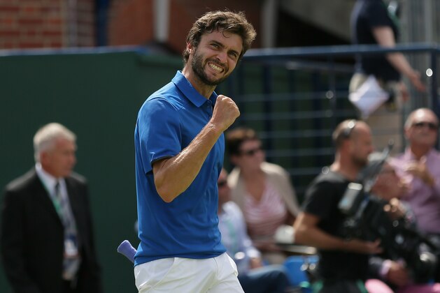 France's Gilles Simon celebrates beating Britain's James Ward in the quarterfinal match between Britain and France in the Davis Cup at the Queen's Club in London, Friday July 17, 2015. (AP Photo/Tim Ireland)