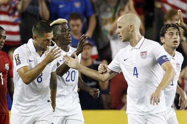 USA's Michael Bradley (4) is congratulated by Clint Dempsey (8) and Gyasi Zardes (20) after scoring against Panama in the second half of a CONCACAF Gold Cup soccer match, Monday, July. 13, 2015, in Kansas City, Kan. The match ended in a 1-1 tie. (AP Photo/Colin E. Braley)