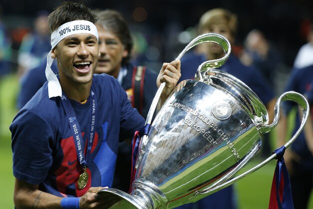 Barcelona's Neymar celebrates with the trophy after the Champions League final soccer match between Juventus Turin and FC Barcelona at the Olympic stadium in Berlin Saturday, June 6, 2015. Barcelona won the match 3-1.   (AP Photo/Luca Bruno)