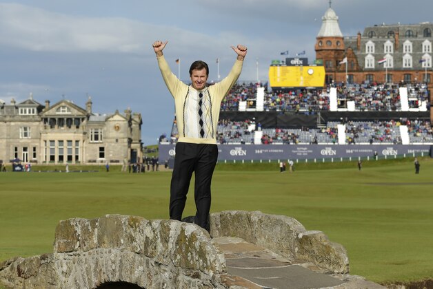 England’s Nick Faldo waves as he poses for photographers on the Swilcan Bridge during the second round of the British Open Golf Championship at the Old Course, St. Andrews, Scotland, Friday, July 17, 2015. (AP Photo/David J. Phillip)