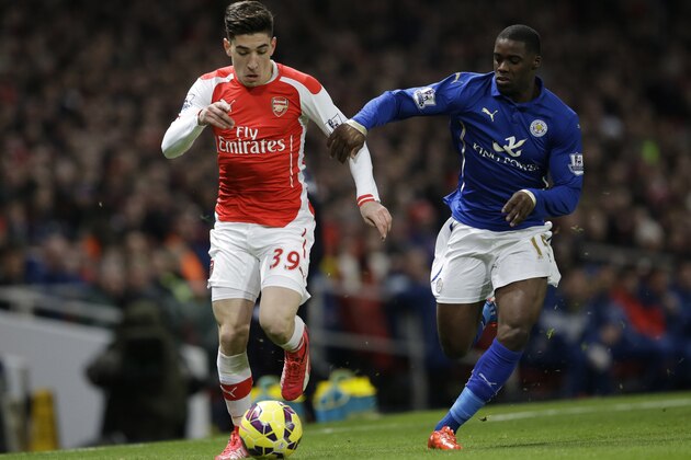 Arsenal's Hector Bellerin, left, competes for the ball with Leicester City's Jeff Schlupp during the English Premier League soccer match between Arsenal and Leicester City at the Emirates Stadium in London, Tuesday, Feb. 10, 2015.  (AP Photo/Matt Dunham)