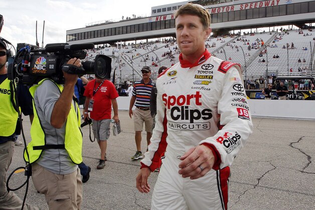 Carl Edwards leaves the track after taking the pole position for Sunday's NASCAR Sprint Cup series auto race at New Hampshire Motor Speedway, Friday, July 17, 2015, in Loudon, N.H. (AP Photo/Jim Cole)
