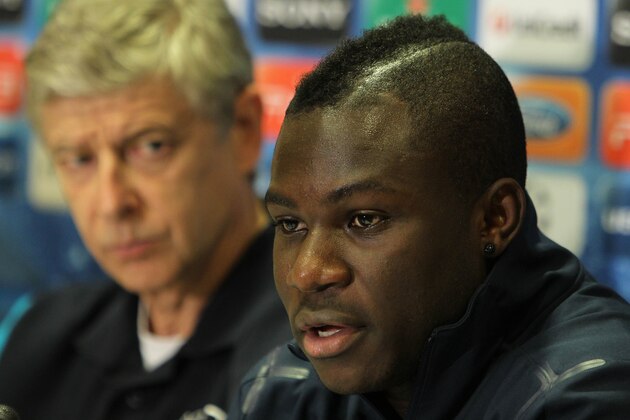Arsenal's Emmanuel Frimpong speaks as his coach Arsene Wenger of France looks on during a press conference in Athens, Monday, Dec. 5, 2011. Arsenal will face Olympiakos for the Champions League Group F soccer match on Tuesday. (AP Photo/Thanassis Stavrakis)