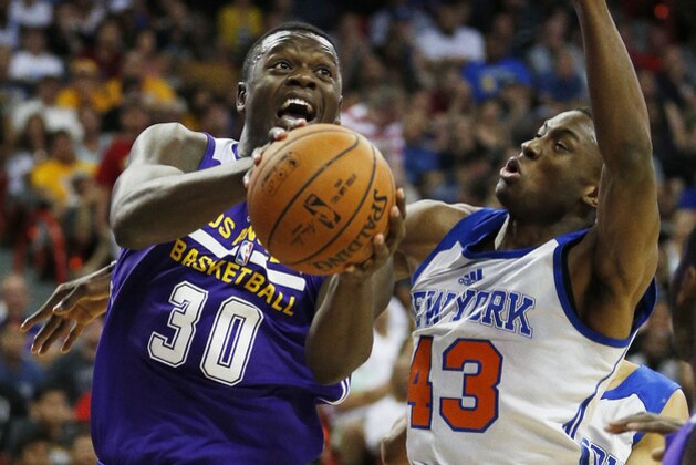Los Angeles Lakers’ Julius Randle, left, shots by New York Knicks’ Thanasis Antetokounmpo during the first half of an NBA summer league basketball game Monday, July 13, 2015, in Las Vegas. (AP Photo/John Locher)
