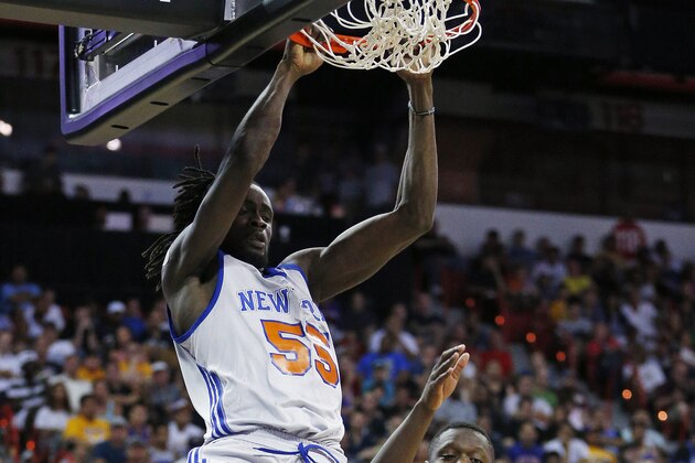 New York Knicks’ Maurice Ndour dunks over Los Angeles Lakers’ Julius Randle during the second half of an NBA summer league basketball game Monday, July 13, 2015, in Las Vegas. (AP Photo/John Locher)