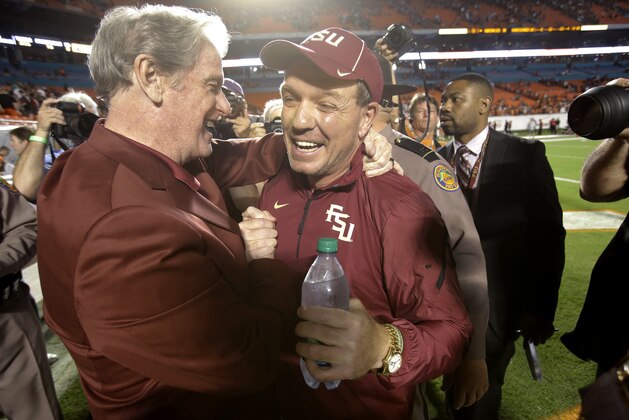 Florida State president John Thrasher, left, congratulates head coach Jimbo Fisher after Florida State defeated Miami 30-26 in an NCAA College football game, Saturday, Nov. 15, 2014 in Miami Gardens, Fla. (AP Photo/Wilfredo Lee)