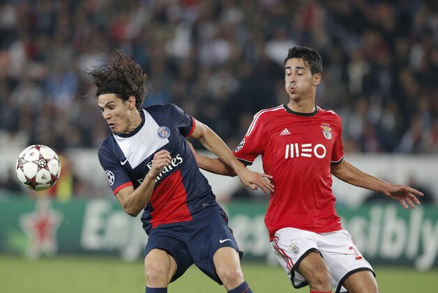PSG's Edinson Cavani, left, challenges for the ball with Benfica's Andre Almeida during the Champions League group C soccer match between Paris Saint Germain and Benfica, at the Parc des Princes stadium, in Paris, Wednesday, Oct. 2, 2013. (AP Photo/Christophe Ena)