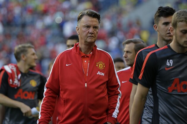 Manchester United manager Louis van Gaal, center, walks with his players onto the pitch at CenturyLink Field before an international friendly soccer match against Club America, Friday, July 17, 2015, in Seattle. (AP Photo/Ted S. Warren)