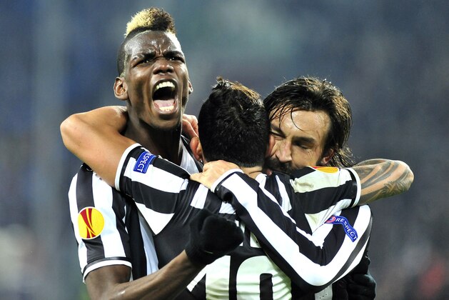 Juventus midfielder Paul Pogba, of France, celebrates after scoring with teammates Andrea Pirlo, right, and Carlos Tevez, center, during the Europa League, round of 16th, soccer match between Juventus and Trabzonspor at the Juventus stadium, in Turin, Italy, Thursday, Feb. 20, 2014. (AP Photo/Massimo Pinca)
