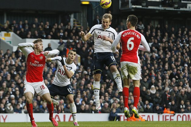 Tottenham’s Harry Kane, second right, heads the ball to score his side's second goal during the English Premier League soccer match between Tottenham Hotspur and Arsenal at the White Hart Lane stadium in London, Saturday, Feb. 7, 2015. (AP Photo/Alastair Grant)