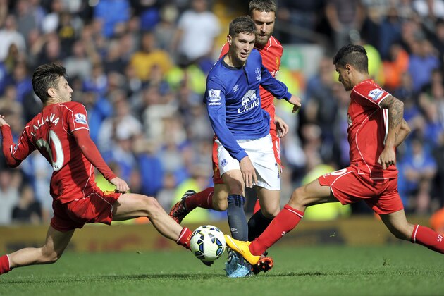 Liverpool's Adam Lallana left, and Philippe Coutinho right, tackle Everton's John Stones centre, during their English Premier League soccer match at Anfield in Liverpool, England, Saturday Sept. 27, 2014. (AP Photo/Clint Hughes) Liverpool's Adam Lallana left, and Philippe Coutinho right, tackle Everton's John Stones centre, during their English Premier League soccer match at Anfield in Liverpool, England, Saturday Sept. 27, 2014. (AP Photo/Clint Hughes)