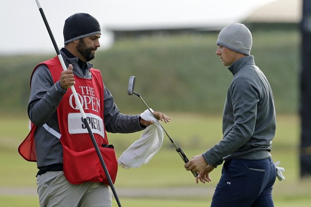 United States’ Jordan Spieth hands his putter to caddie Michael Greller on the 15th green after play was suspended due to strong winds during the second round of the British Open Golf Championship at the Old Course, St. Andrews, Scotland, Saturday, July 18, 2015. (AP Photo/David J. Phillip)