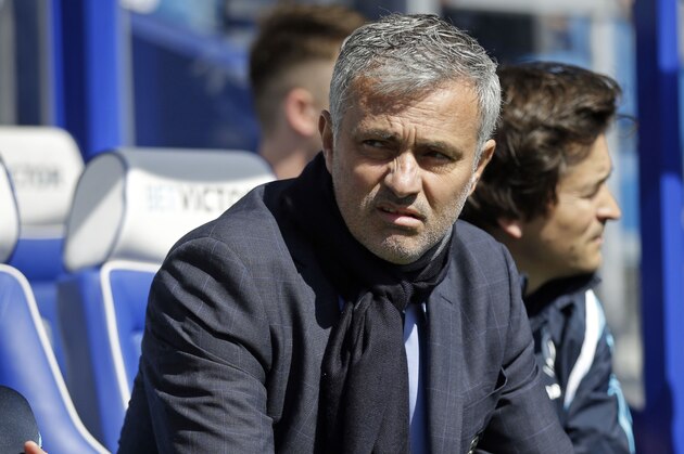 Chelsea's Chelsea manager Jose Mourinho takes his seat on the bench before the English Premier League soccer match between QPR and Chelsea at Loftus Road stadium in London, Sunday, April 12, 2015. (AP Photo/Matt Dunham)