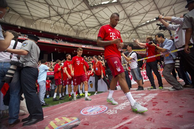 Bayern's Jerome Boateng takes the field with his teammates for a practice session at Beijing National Stadium, also known as the Birds Nest, in Beijing, Friday, July 17, 2015. Bayern Munich will play a friendly match against Valencia in the Chinese capital on Saturday. (AP Photo/Mark Schiefelbein)