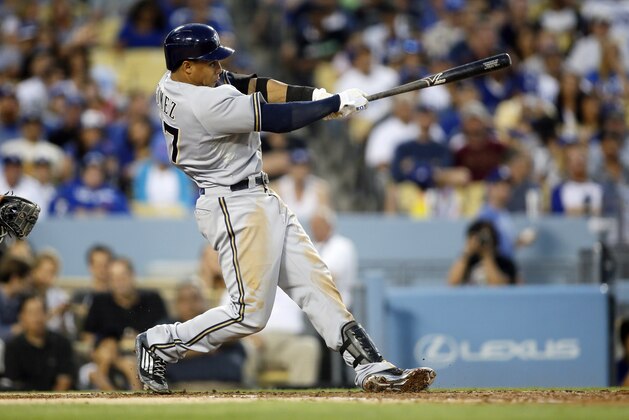 Milwaukee Brewers' Carlos Gomez hits a double to drive in Taylor Jungmann, Ryan Braun, and Adam Lind to score against the Los Angeles Dodgers during the third inning of a baseball game, Saturday, July 11, 2015, in Los Angeles. (AP Photo/Danny Moloshok)