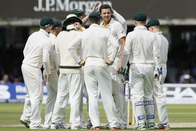 Australia's Josh Hazlewood, centre, celebrates taking the wicket of England's Moeen Ali on the third day of the second Ashes Test match between England and Australia, at Lord's cricket ground in London, Saturday, July 18, 2015. (AP Photo/Kirsty Wigglesworth)