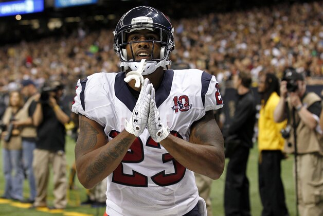 Houston Texans running back Arian Foster (23) celebrates a rushing touchdown in the first half of an NFL preseason football game against the New Orleans Saints in New Orleans, Saturday, Aug. 25, 2012. (AP Photo/Bill Haber)