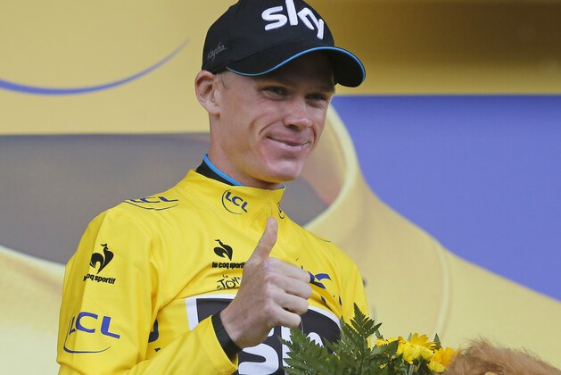 Britain's Chris Froome, wearing the overall leader's yellow jersey, gives a thumbs up as he celebrates on the podium of the twelfth stage of the Tour de France cycling race over 195 kilometers (121.2 miles) with start in Lannemezan and finish in Plateau de Beille, France, Thursday, July 16, 2015. (AP Photo/Christophe Ena)