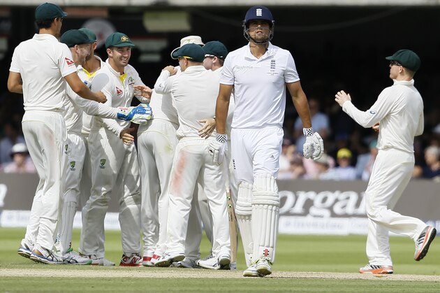 Australia's players celebrate as England's Alastair Cook, centre, leaves the pitch after he is bowled by Australia's Mitchell Marsh on the third day of the second Ashes Test match between England and Australia, at Lord's cricket ground in London, Saturday, July 18, 2015. (AP Photo/Kirsty Wigglesworth)