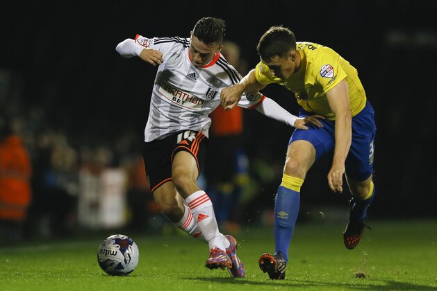 Fulham's Patrick Roberts, left, vies for the ball with Derby's Craig Forsyth during the English League Cup soccer match between Fulham and Derby County at Craven Cottage stadium in London, Tuesday, Oct. 28, 2014. (AP Photo/Kirsty Wigglesworth)