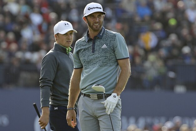 United States’ Dustin Johnson, left, follows his drive from the 18th tee as United States’ Jordan Spieth walks onto the tee during the second round of the British Open Golf Championship at the Old Course, St. Andrews, Scotland, Saturday, July 18, 2015. (AP Photo/David J. Phillip)