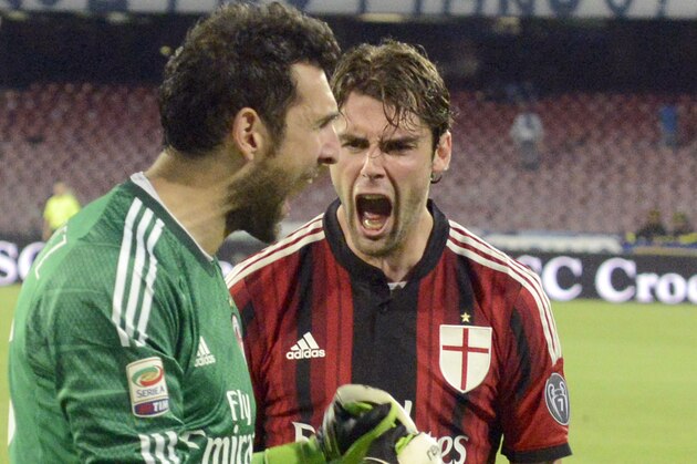 AC Milan goalkeeper Diego Lopez, left, celebrates with his teammate Andrea Poli after he saved a penalty kick during a Serie A soccer match between Napoli and AC Milan, at the San Paolo stadium in Naples, Italy, Sunday, May 3, 2015. (AP Photo/Salvatore Laporta)