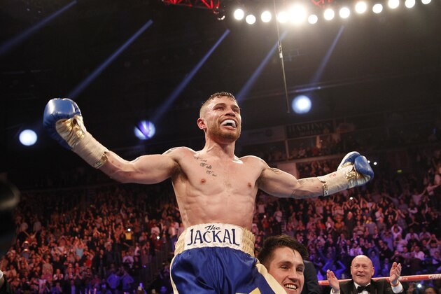 World champion Carl Frampton celebrates with his trainer Shane McGuigan after defeating Chris Avalos of the U.S. during the IBF super bantamweight world boxing title fight at the Odyssey arena, Belfast, Northern Ireland, Saturday, Feb. 28, 2015. (AP Photo/Peter Morrison)