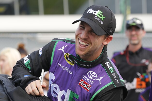 Denny Hamlin climbs in his car on pit road during NASCAR qualifying at Daytona International Speedway, Saturday, July 4, 2015, in Daytona Beach, Fla.  (AP Photo/Terry Renna)