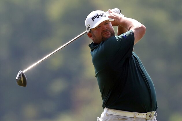 Jason Gore watches his tee shot on the 18th hole during the third round of the Barbasol Championship golf tournament, Saturday, July 18, 2015, in Opelika, Ala. (AP Photo/Butch Dill)
