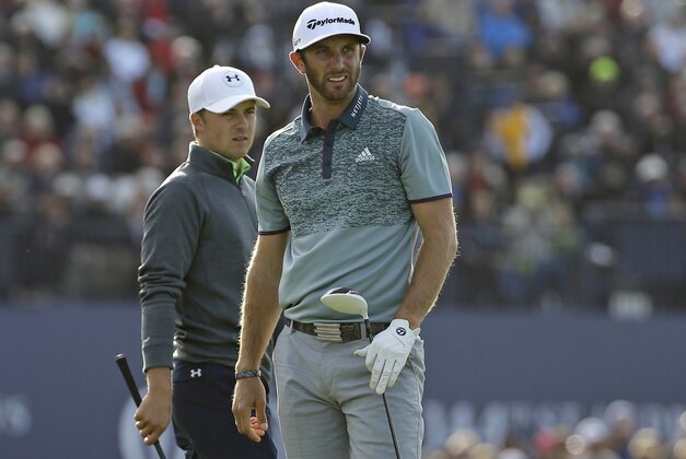 United States’ Dustin Johnson, left, follows his drive from the 18th tee as United States’ Jordan Spieth walks onto the tee during the second round of the British Open Golf Championship at the Old Course, St. Andrews, Scotland, Saturday, July 18, 2015. (AP Photo/David J. Phillip)