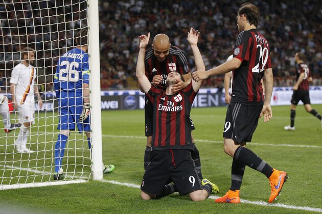 AC Milan’s Mattia Destro celebrates with his teammates Alex Dias da Costa and Gabriel Paletta, right, after scoring during a Serie A soccer match between AC Milan and Roma, at the San Siro stadium in Milan, Italy, Saturday, May 9, 2015. (AP Photo/Luca Bruno)