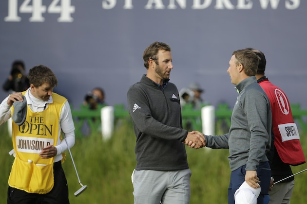 United States’ Jordan Spieth, right, shakes hands with United States’ Dustin Johnson after finishing their round on the 18th green during the second round of the British Open Golf Championship at the Old Course, St. Andrews, Scotland, Saturday, July 18, 2015. (AP Photo/David J. Phillip)
